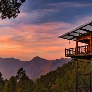 Top Station Viewpoint Munnar sunset with dramatic orange sky and misty mountain valleys below
